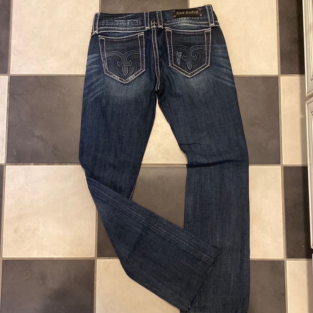 Rock Revival boot cut jeans. Simple brand pattern on back pocket.